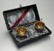 An Edwardian pair of plated cauldron fluted table salt sellers raised on triple ball feet with