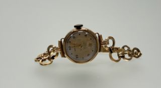 A Vintage Marvin 9ct gold wristwatch with silvered dial roman numerals and subsidiary seconds dial