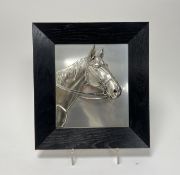 A metal horse relief picture within a black wooden frame (h. 24.5cm x 21.5cm)