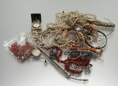A collection of costume jewellery to include paste pearl necklaces, gilt metal chains, a sterling