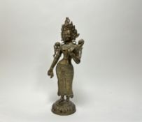 A cast brass figure of Hindu Goddess of Parvati on a circular pierced base (h. 52cm)