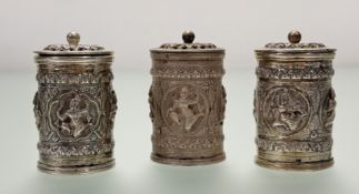 A set of three eastern pepperettes with traditional god and dancing figure panels: h. x 6cm d. x 3.