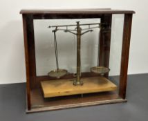 A W & J. George Ltd of Birmingham cased chemist scales, presented in a mahogany glazed case on a