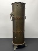 An Arts and Crafts hammered brass and copper umbrella stand in shell case form, with studded detail,
