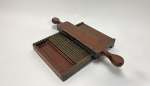 A 19thc mahogany and brass chemist's pill making machine (l. 31cm)