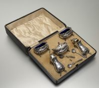 A Birmingham silver five-piece condiment set in the Georgian style comprising a pair of salt cellers