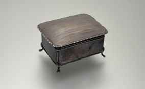 An Edwardian Birmingham silver ring box with engine turned decoration and hinged top raised on pad