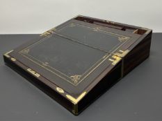 A 19thc Indian rosewood brass bound writing slope, the hinged lid revealing a fitted interior with