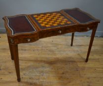 A reproduction brass-mounted mahogany games table. by Maitland-Smith, shaped top with central inlaid