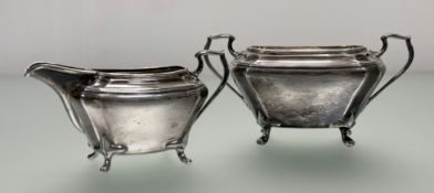 A Queen Elizabeth II Sheffield silver two handled sugar basin and milk jug of panelled form,