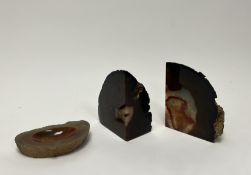 A pair of agate geode polished crystal bookends, together with a banded agate geode specimen dish,