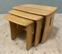 A contemporary set of three elm nesting tables by Ercol, rectangular tops with rounded edges on