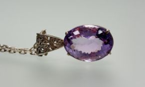 A silver oval faceted amethyst set pendant: l. x 2.5cm w. x 2cm on steling silver chain link