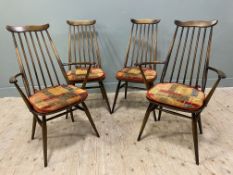 A set of four mid-century Ercol elm dining chairs, two plus two carvers, with shaped top and spindle