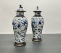 A pair of late 19thc/early 20thc Chinese blue and white crackle glaze vases with covers, blue floral