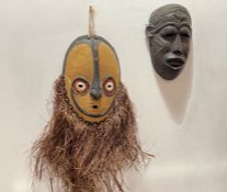 A tribal Angoram mask style, Papua New Guinea, decorated with natural yellow, red, white, and black,