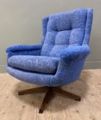 A Mid-century revolving armchair, arched top and open arms, with cushioned button-back and seats, in