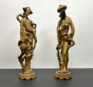A pair of vintage chinoiserie cast resin figures moulded as male and female statues of good luck,
