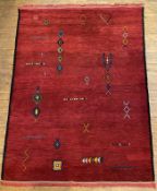 A large modern hand-knotted Moroccan carpet, central panel with geometric tribal motifs on a deep