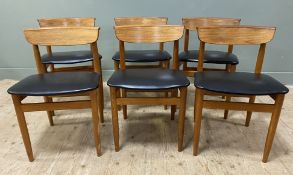 A set of six Mid-century teak dining chairs, with curved backs and black leather upholstered
