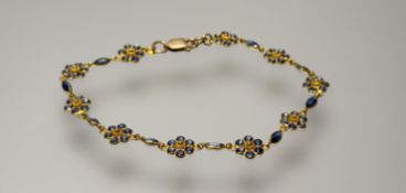A Thai 18ct gold floral cluster panel bracelet set 69 sapphires approximately 5ct with lobster