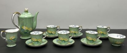 A Crown Staffordshire tea service decorated with water lilies on a green ground comprising six