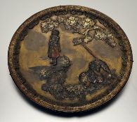 A Japanese Pottery plaque depicting a fallen warrior figure looking up to a demon faced figure, with
