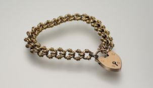 A 9ct gold ring and knot pattern chain link bracelet with 9ct gold heart shaped padlock and safety