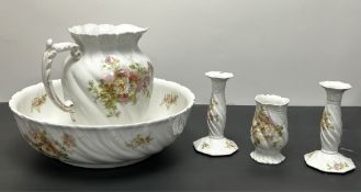 A large Limoges jug and basin, decorated with floral sprigs on a white ground, with fluted shaped