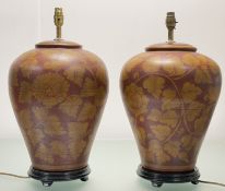 A pair of decorative large baluster golden scrolling folite design on burgundy ceramic table