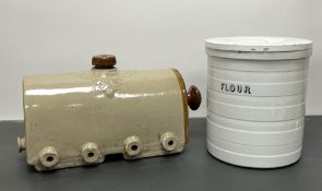 A stoneware two-tone pig feeder with ten spaces and screw top lid (w. 36cm), together with an