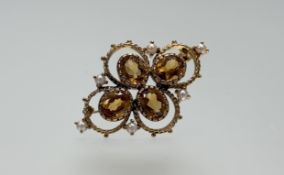 An Edwardian style 9ct gold brooch set four oval faceted citrines each approximately 1ct flanked