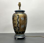 A contemporary table lamp decorated in the Art Deco style with gilt decoration, raised on a