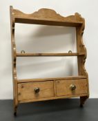 A wooden bathroom wall rack shelf with three long shelves above two short drawers, wall-hanging