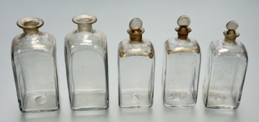 A collection of five graduated Dutch Gin bottles, with gilt feather the sun and stars to top,