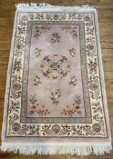 A modern Chinese Peking wool rug, central panel with medallion and floral motifs, enclosed within
