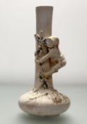 An Art Nouveau plaster vase, with moulded boy climbing vine to neck. (losses to plaster figure/vine)