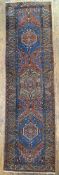 An early 20th century North West Persian Heriz runner, central panel with geometric medallion