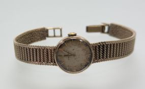 A vintage Omega 9ct gold manual wind wristwatch with gilt dial and baton hour markers: d. x 1.5cm on