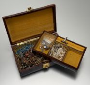 A brown leather jewellery box containing a collection of costume jewellery to include a Chinese