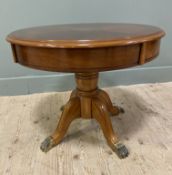 A reproduction Yew wood coffee table, circular banded top with central inlaid patera, on a turned