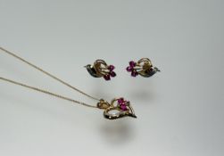 A Thai 14ct gold heart shaped pendant set three navette shaped rubies approximately 0.6ct with