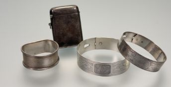 A silver cuff style adjustable bracelet with scrolling engraved decoration and engraved initials