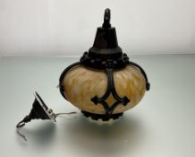 An Edwardian porch light with yellow mottled hand-blown glass within a cast iron gothic style