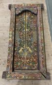 An early 20th century Burmese carved hardwood doorframe, frame with heavily carved flowerheads and