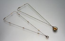 A Canadian 9ct gold chain link and bar necklace with 9ct gold horseshoe pendant: l. x 24cm 2.19g and