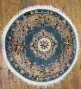A modern Chinese circular rug, central floral medallion enclosed within a border of scrolling