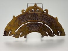 A Carved Chinese brown jadeite arched pendant, with two double headed dragons, and scrolling pierced