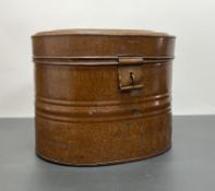 An early 20thC tin hat box of oval form with cobalt blue interior, the hinged lid complete with a