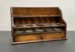 An early 20thC fruitwood apothecary bottle holder, one long drawer above a set of two shelves with